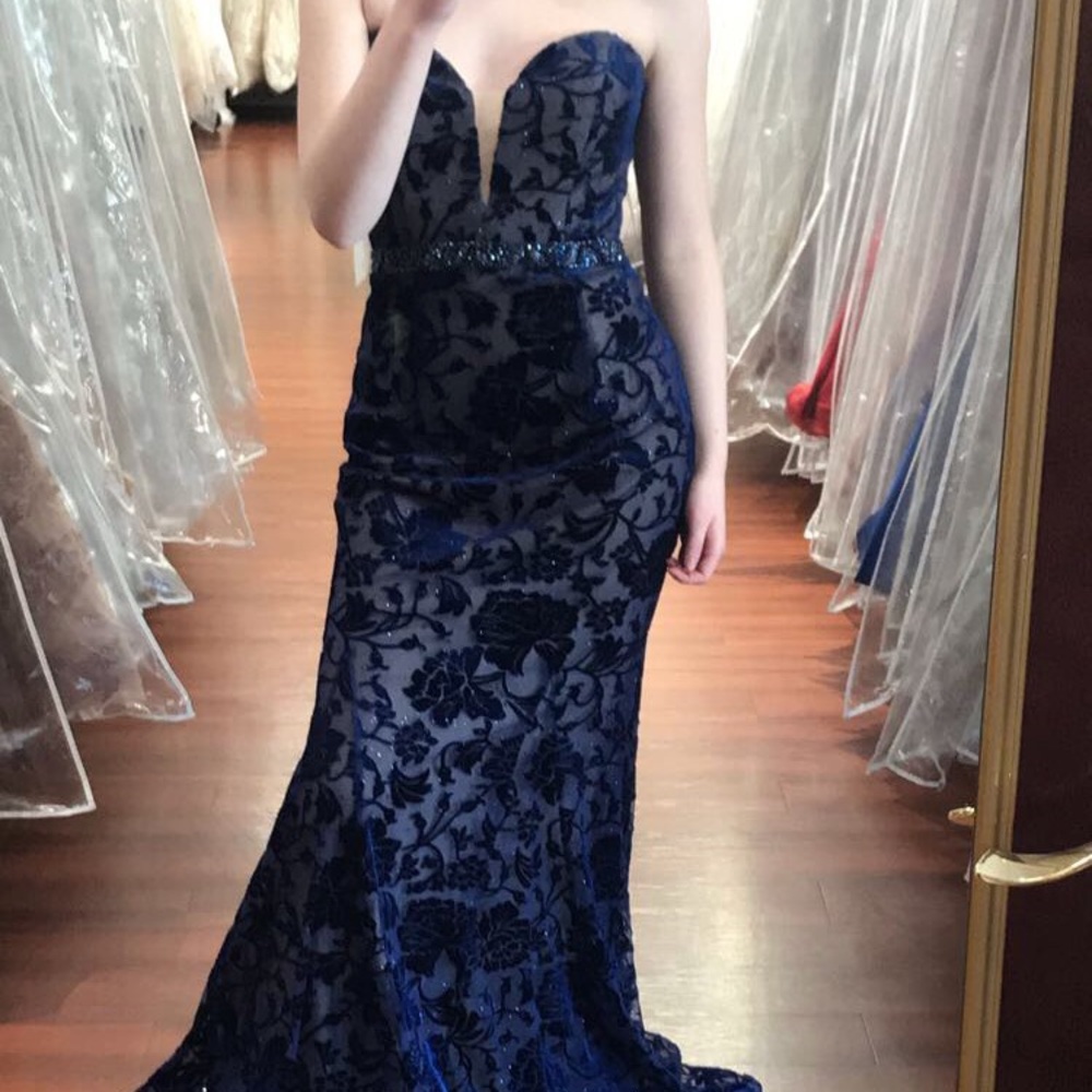 Beautiful, slim-fitting grad dress with designs.